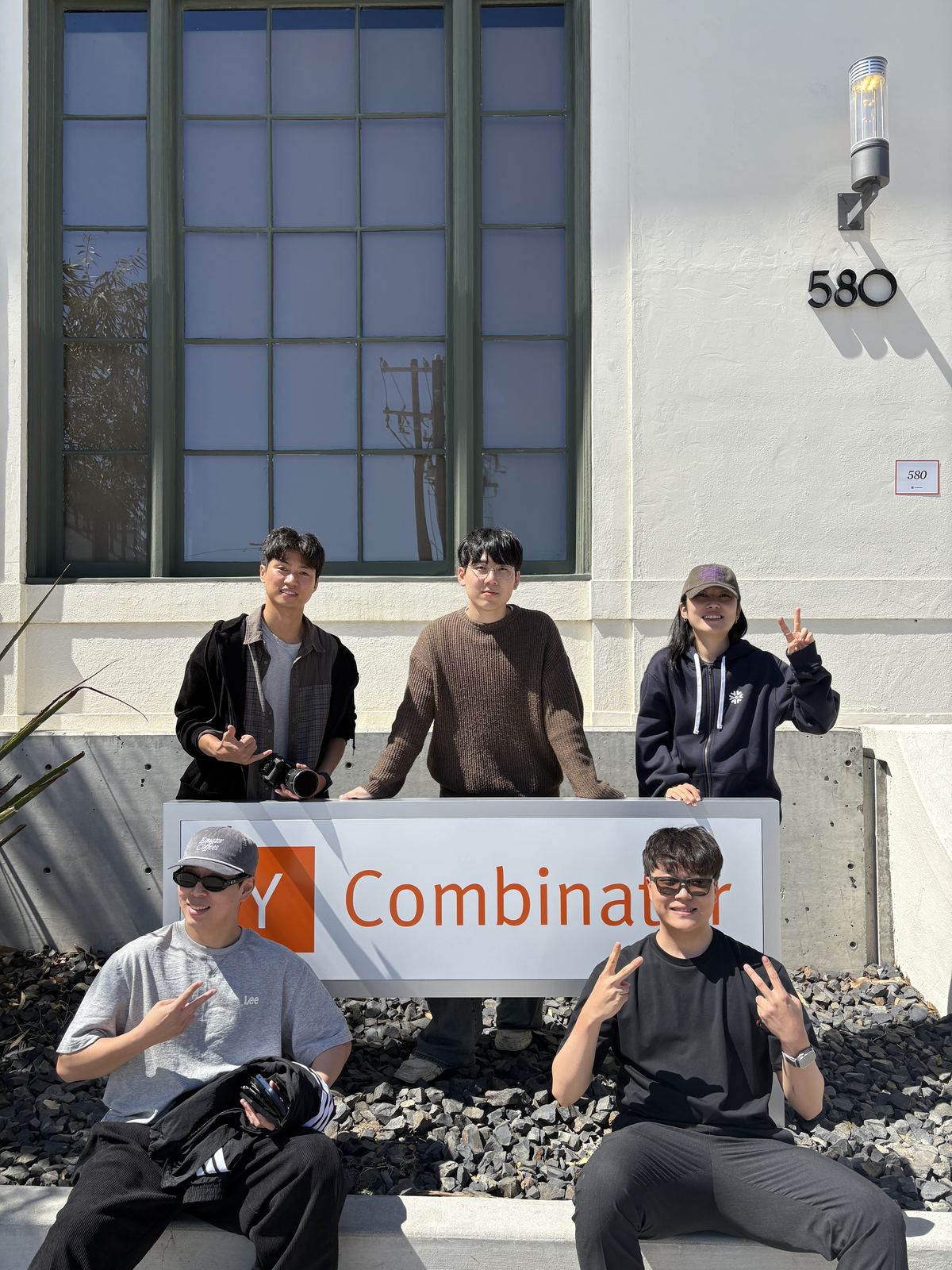 Zerobase founders at the Y Combinator sign
