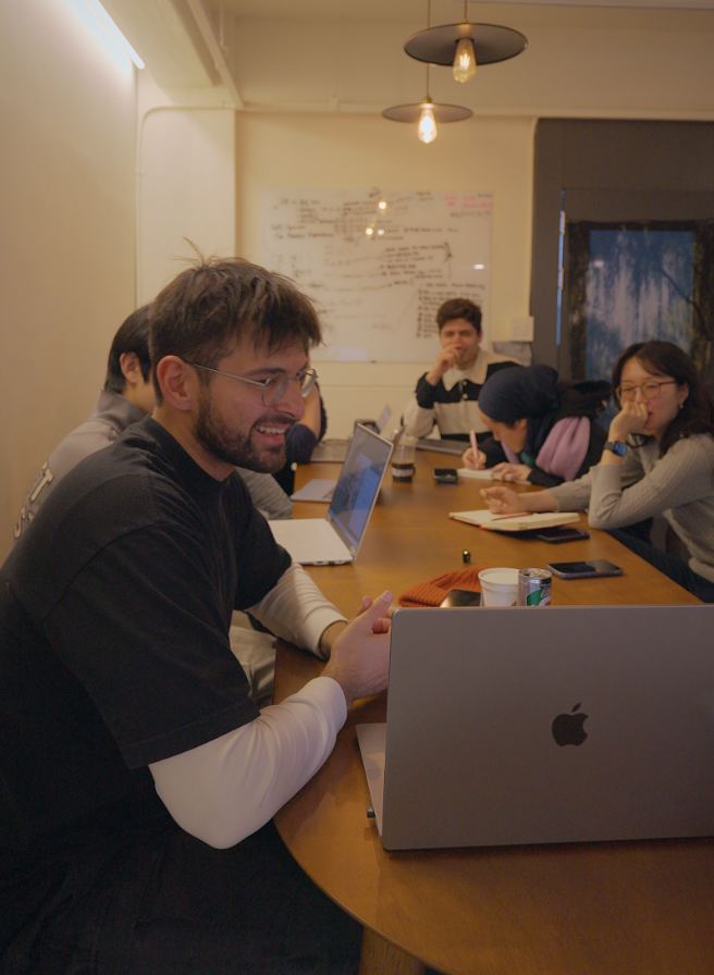 Founders working on their startups around a table at Zerobase